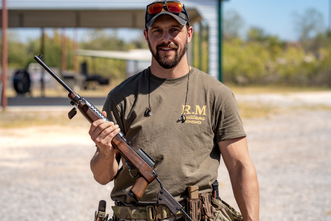 A professional firearms instructor with a rifle at the private range near Houston